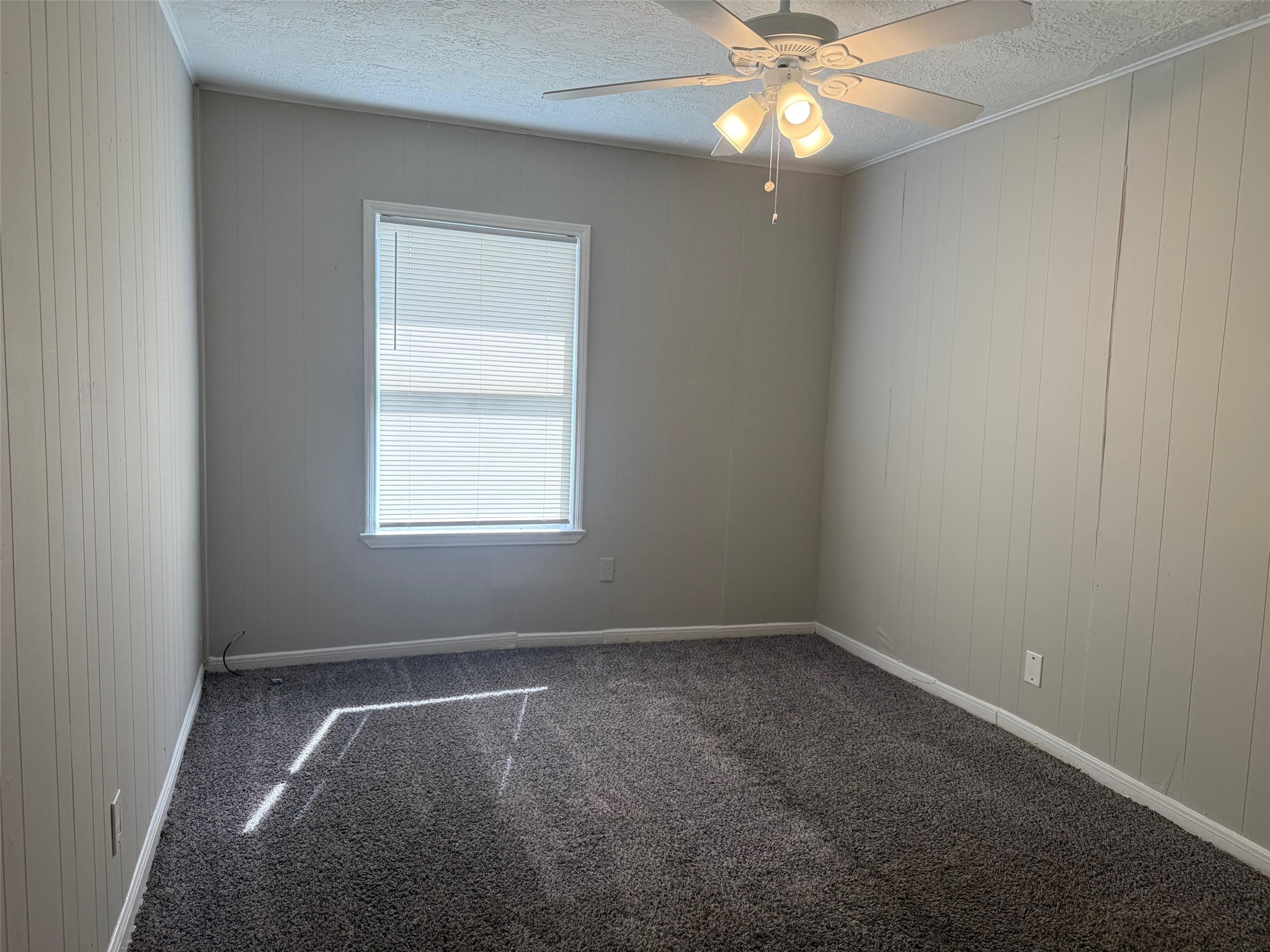 5933 Southgood Street Houston, TX 77033 - Photo 7 of 10 an empty room with a window and a fan