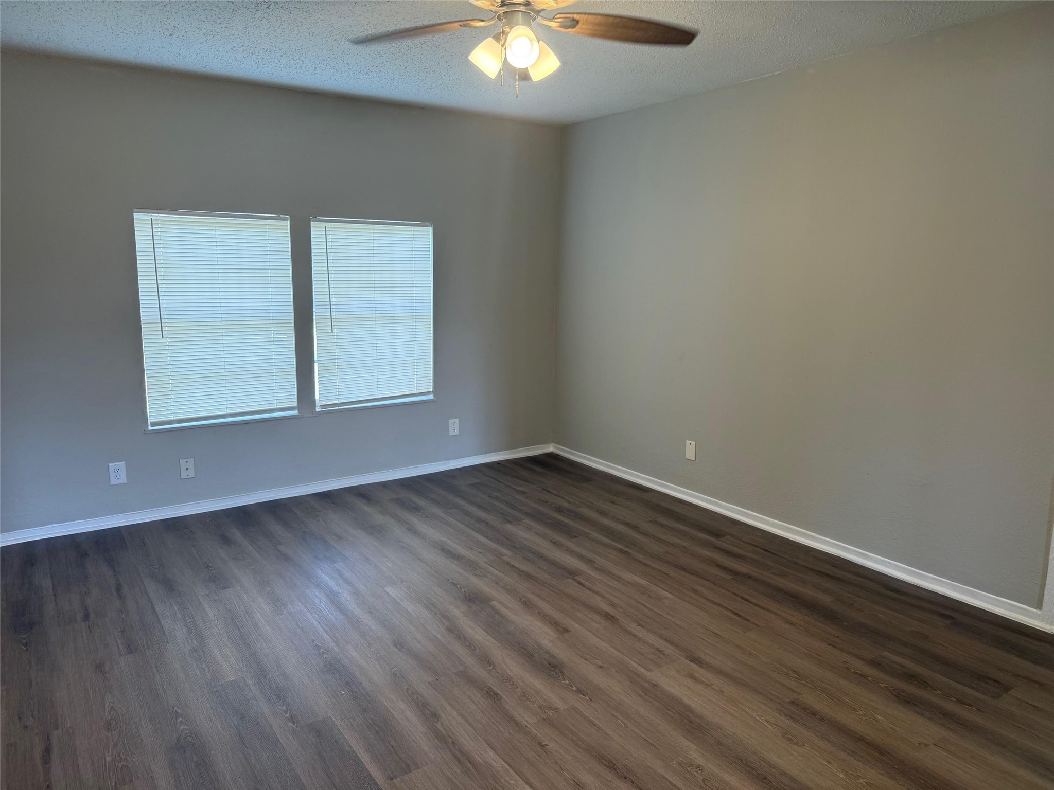 5933 Southgood Street Houston, TX 77033 - Photo 8 of 10 an empty room with wooden floor and windows