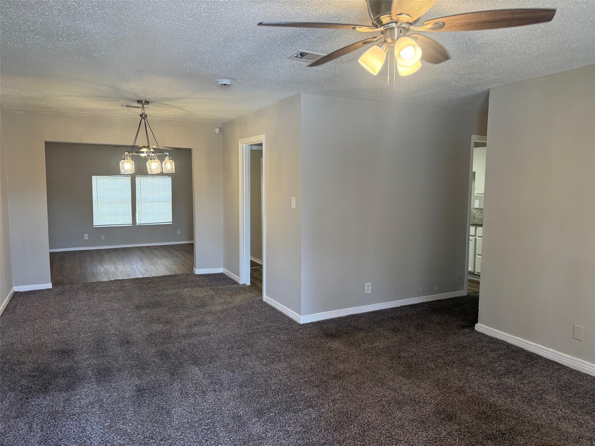5933 Southgood Street Houston, TX 77033 - Photo 9 of 10 an empty room with chandelier fan and windows
