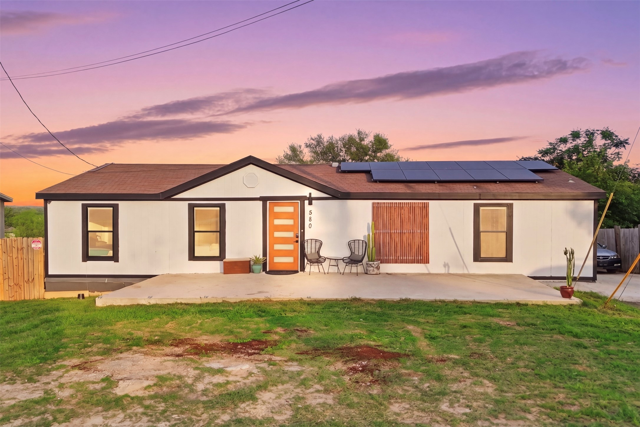 580 Railyard Drive Kyle, TX 78640 - Photo 1 of 20 The property features a white exterior, a brown roof, and solar panels