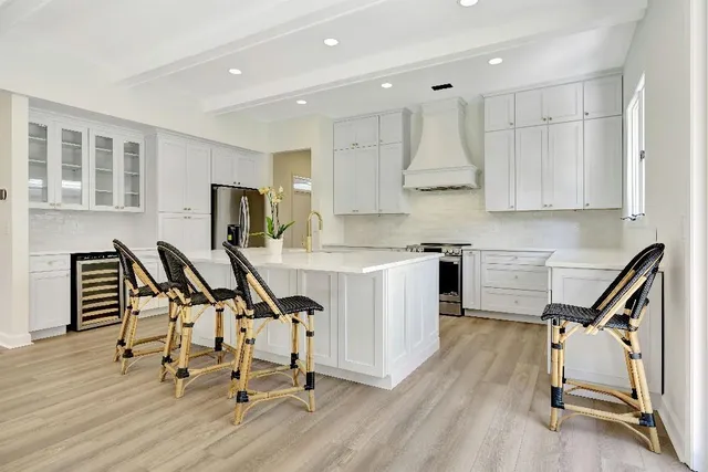 a bedroom with a large bed couch and a large window