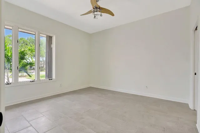 a sign of golf club on a wall under a large tree