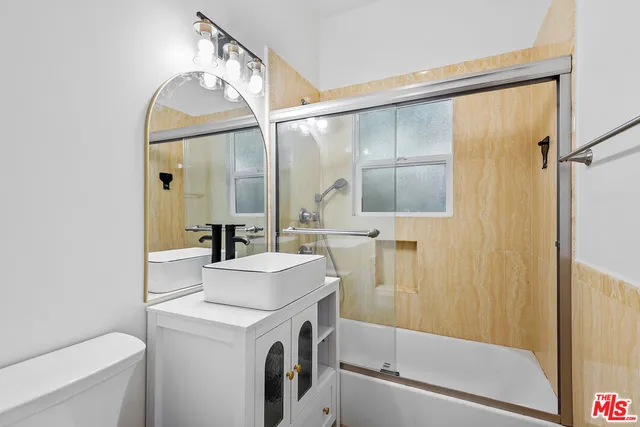 a backyard of a house with plants and large trees