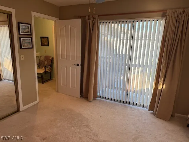 a view of a livingroom with an empty space and a window