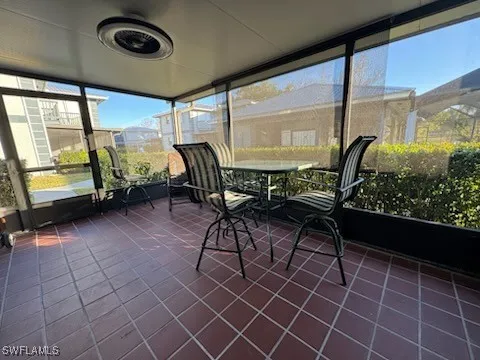 a dining room with furniture and a floor to ceiling window