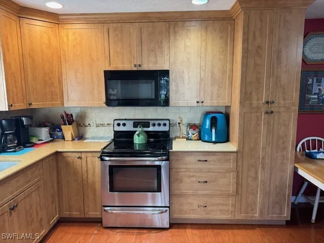 a kitchen with granite countertop a stove and a sink