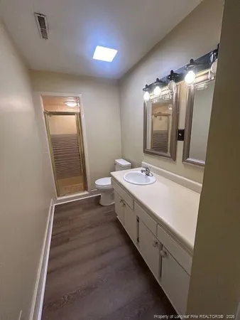 a bathroom with a double vanity sink and mirror