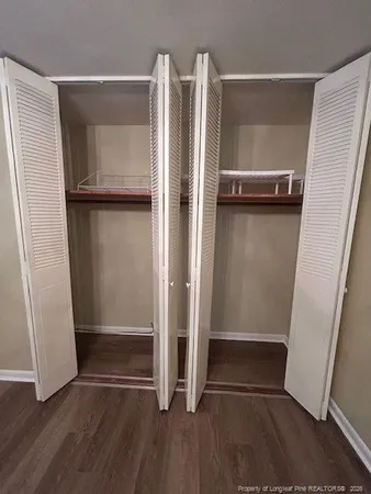 a view of walk in closet with empty racks