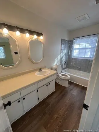 a spacious bathroom with double vanity and a mirror
