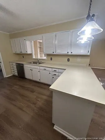 a kitchen with a sink a stove and cabinets