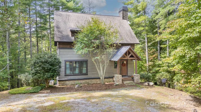 front view of a house with a yard and potted plants