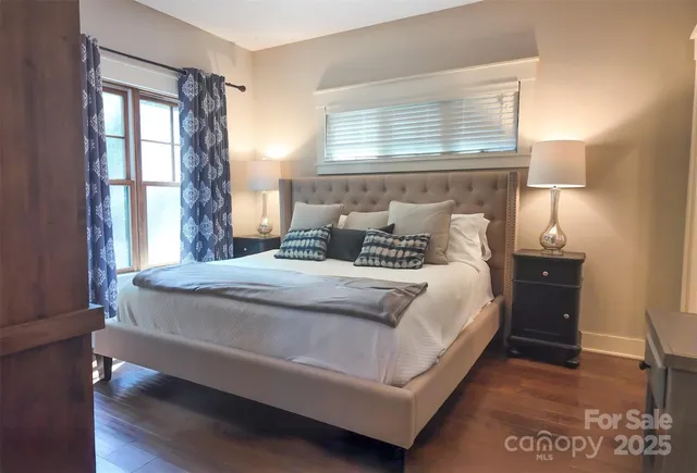 a bed sitting in a bedroom next to a window