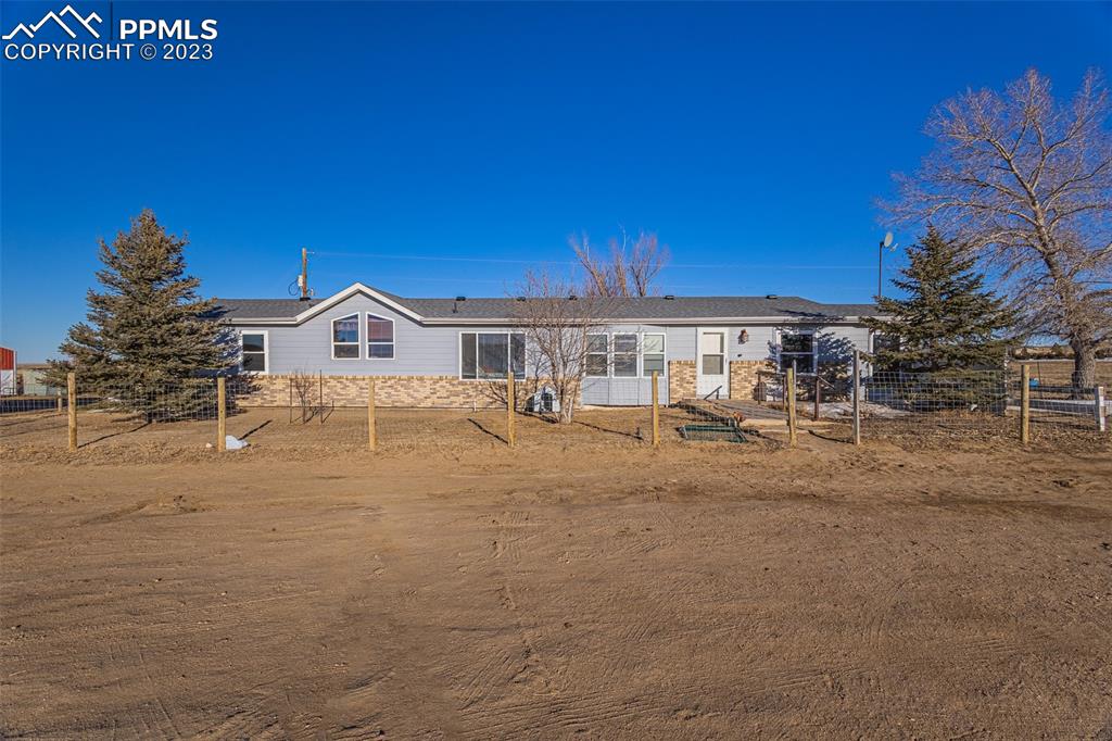 a view of house with outdoor space and sitting area