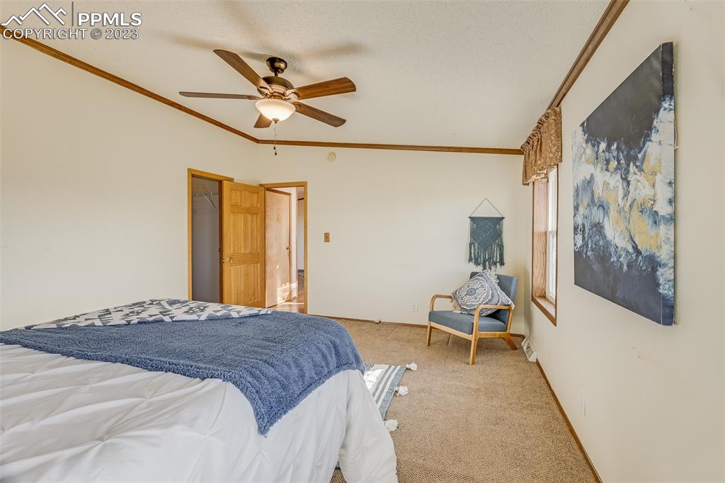 29550 Paint Mine Road Calhan, CO 80808 - Photo 11 of 33 a bedroom with a bed and table chair