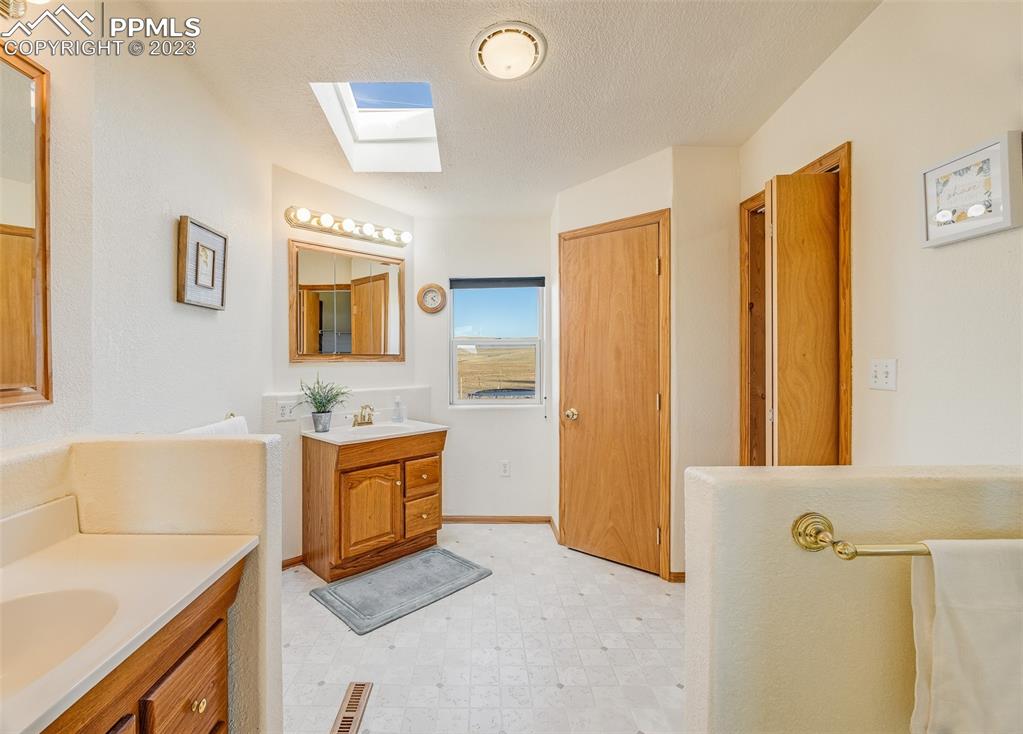 29550 Paint Mine Road Calhan, CO 80808 - Photo 12 of 33 a bathroom with a sink a washer and dryer