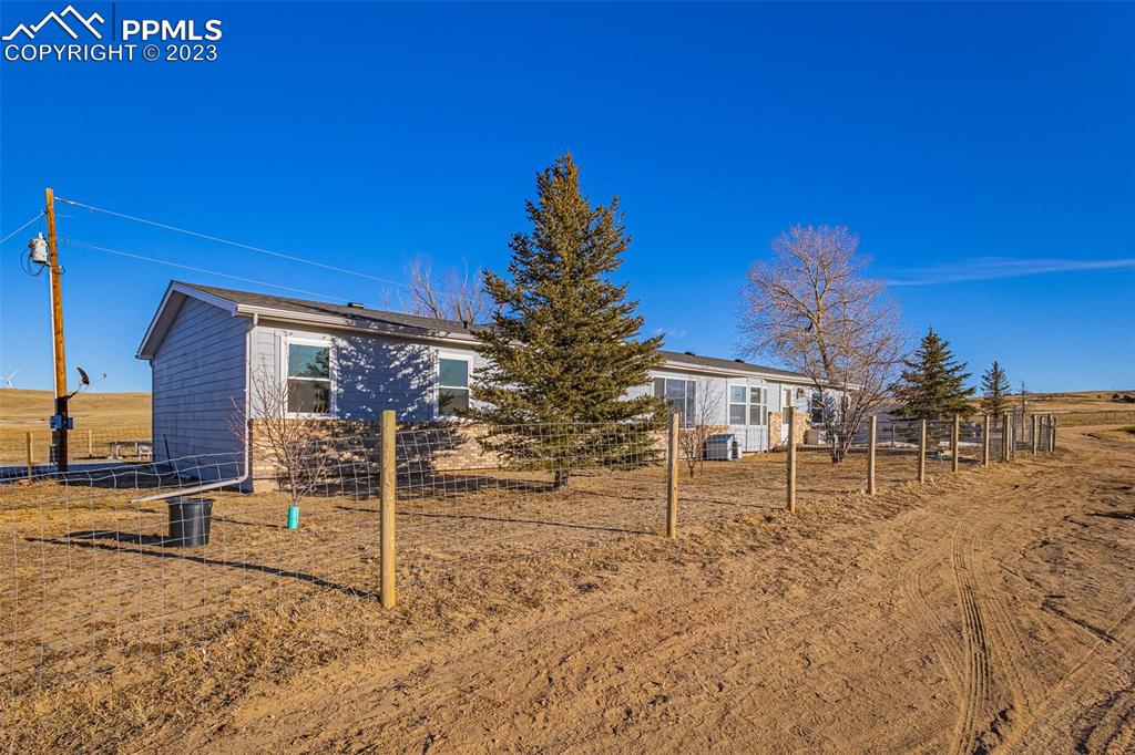 29550 Paint Mine Road Calhan, CO 80808 - Photo 2 of 33 a view of a house with a yard