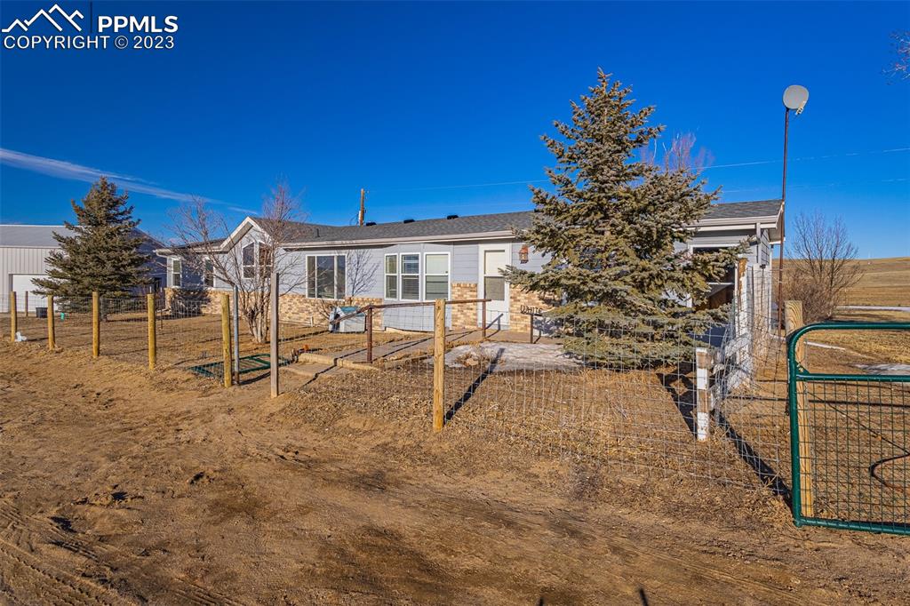 29550 Paint Mine Road Calhan, CO 80808 - Photo 33 of 33 a view of a chairs with table in front of house