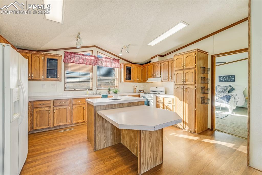 29550 Paint Mine Road Calhan, CO 80808 - Photo 5 of 33 a kitchen with stainless steel appliances granite countertop a stove a sink dishwasher and a refrigerator with wooden floor