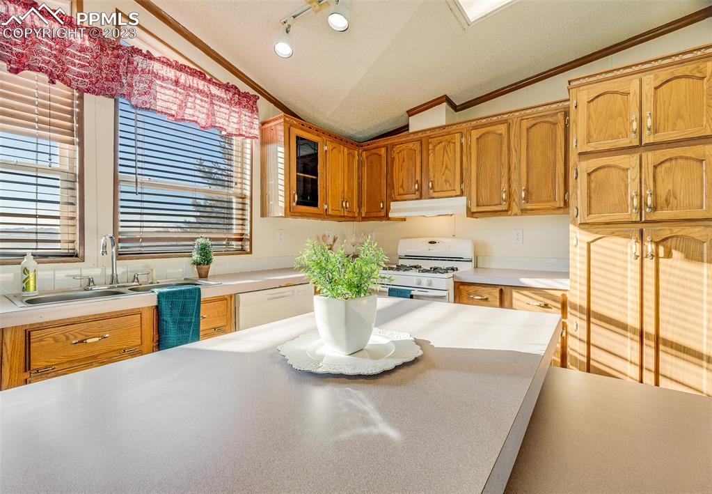 29550 Paint Mine Road Calhan, CO 80808 - Photo 7 of 33 a kitchen with stainless steel appliances granite countertop a sink and a granite counter tops with a large window