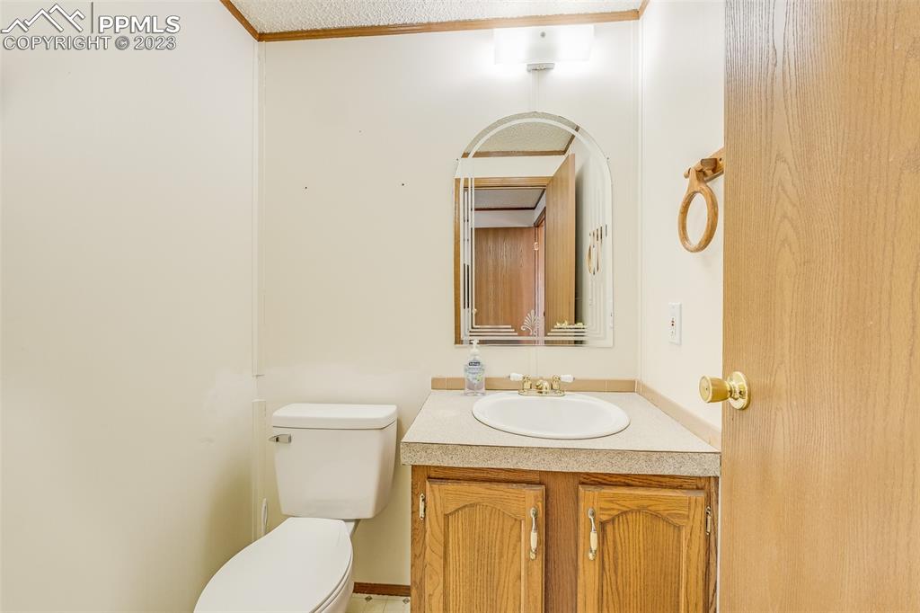 29550 Paint Mine Road Calhan, CO 80808 - Photo 9 of 33 a bathroom with a sink a toilet and mirror
