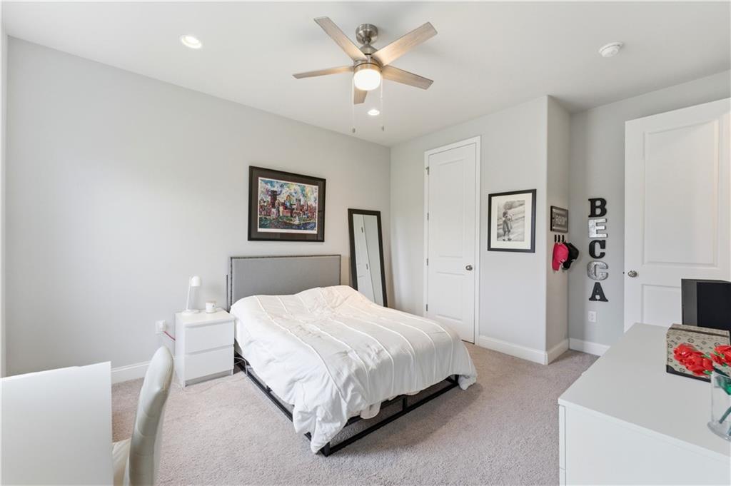 1502 Orion Road Bridgeville, PA 15017 - Photo 23 of 46 a bedroom with a bed and a chandelier