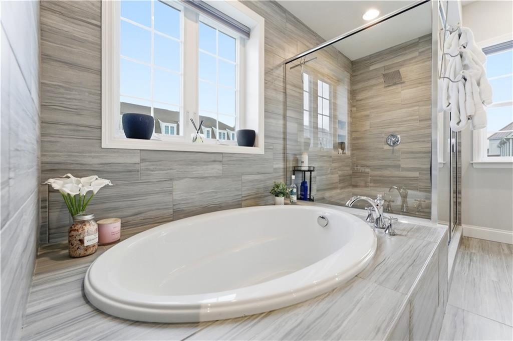 1502 Orion Road Bridgeville, PA 15017 - Photo 28 of 46 a bathroom with a tub a mirror and shower