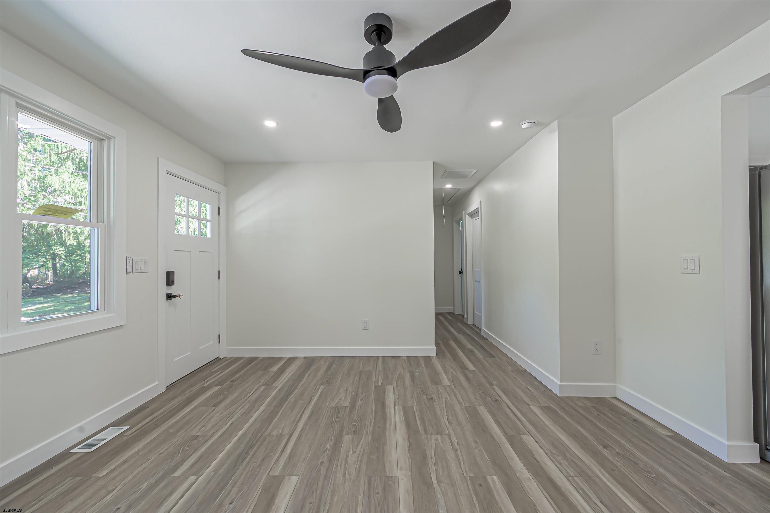 310 Sandy Lane Galloway Township, NJ 08205 - Photo 16 of 48 wooden floor in an empty room with a window
