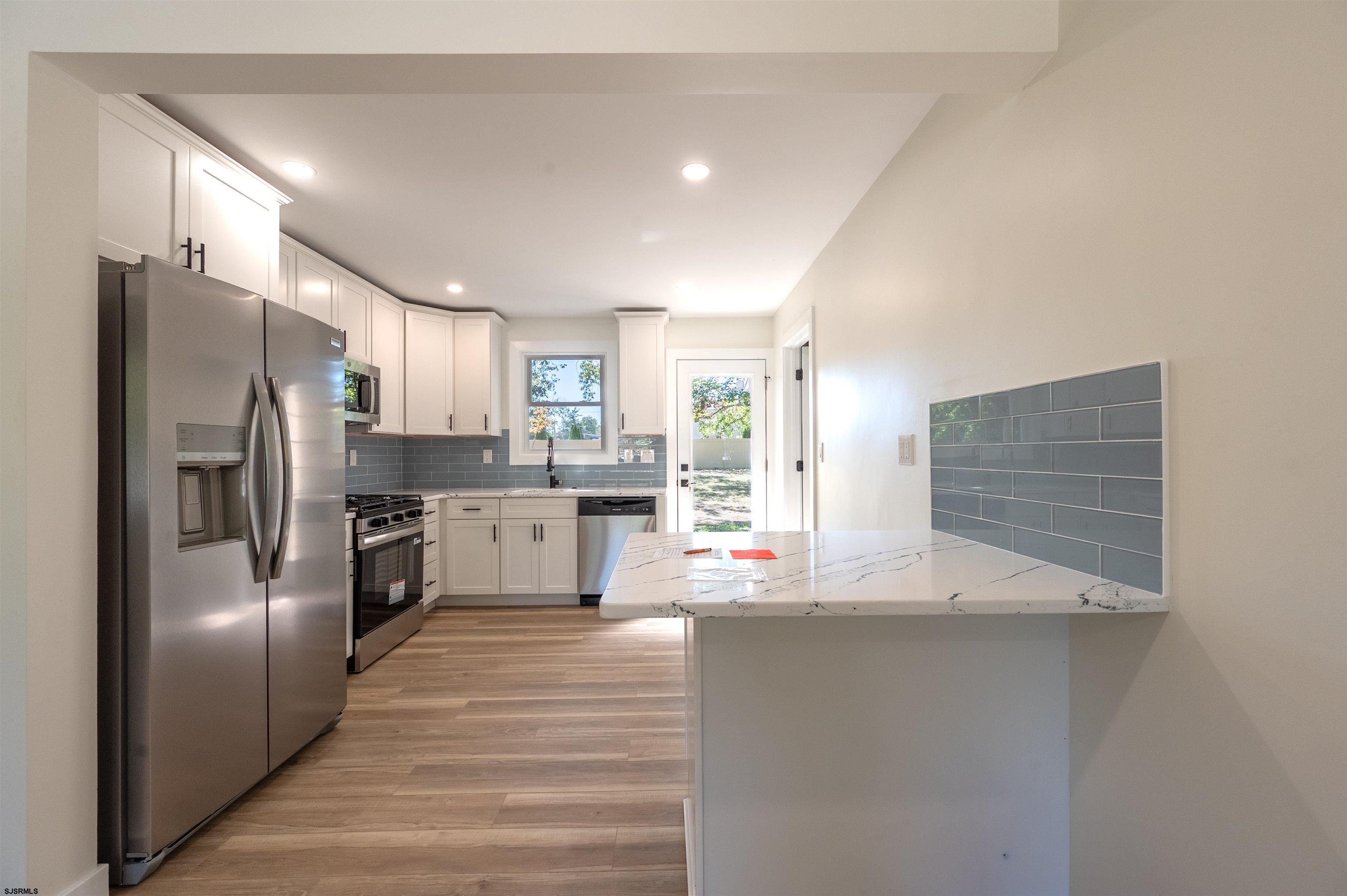 310 Sandy Lane Galloway Township, NJ 08205 - Photo 20 of 48 a kitchen with stainless steel appliances a refrigerator sink and cabinets