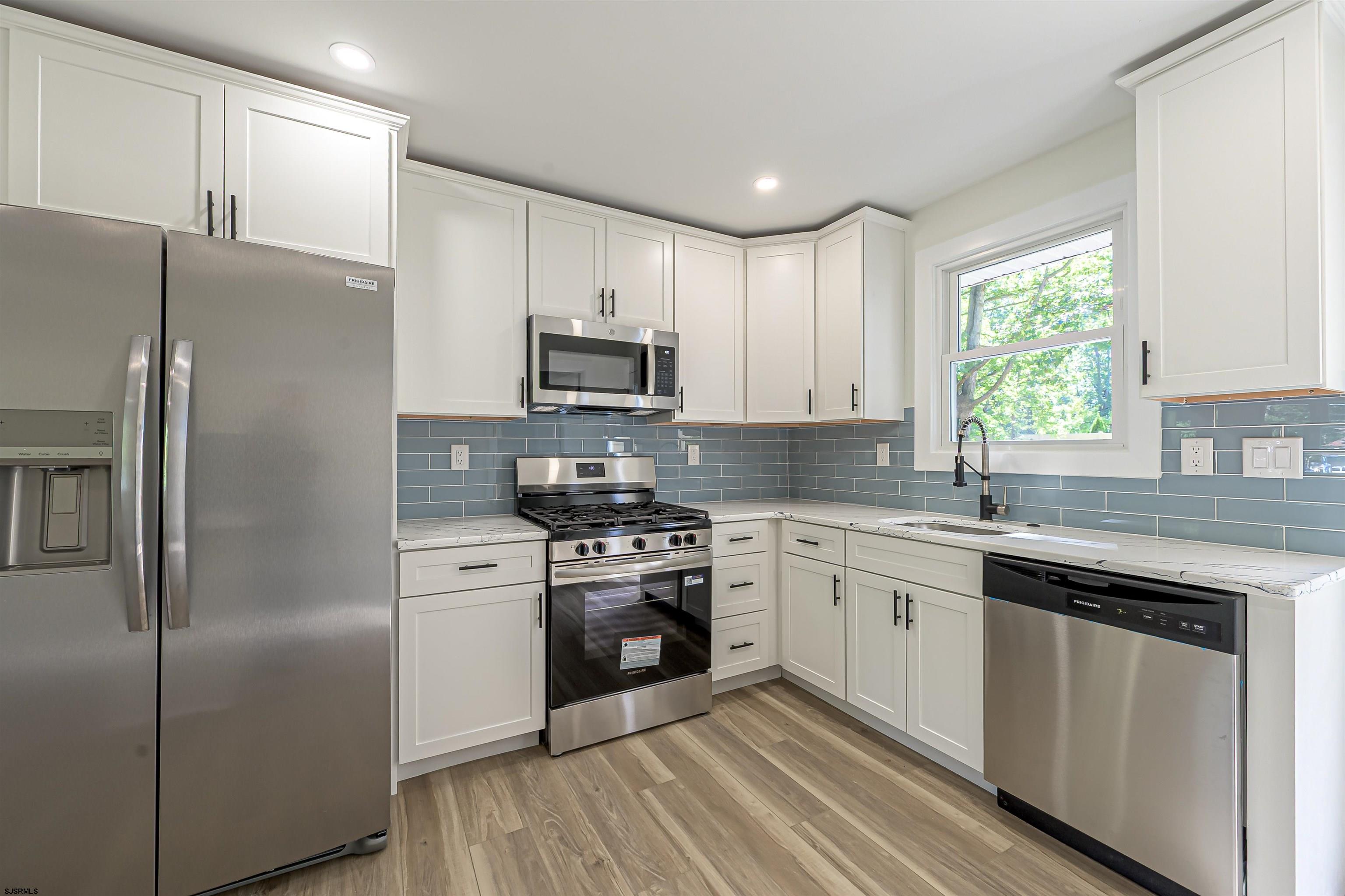 310 Sandy Lane Galloway Township, NJ 08205 - Photo 21 of 48 a kitchen with a sink stove and refrigerator
