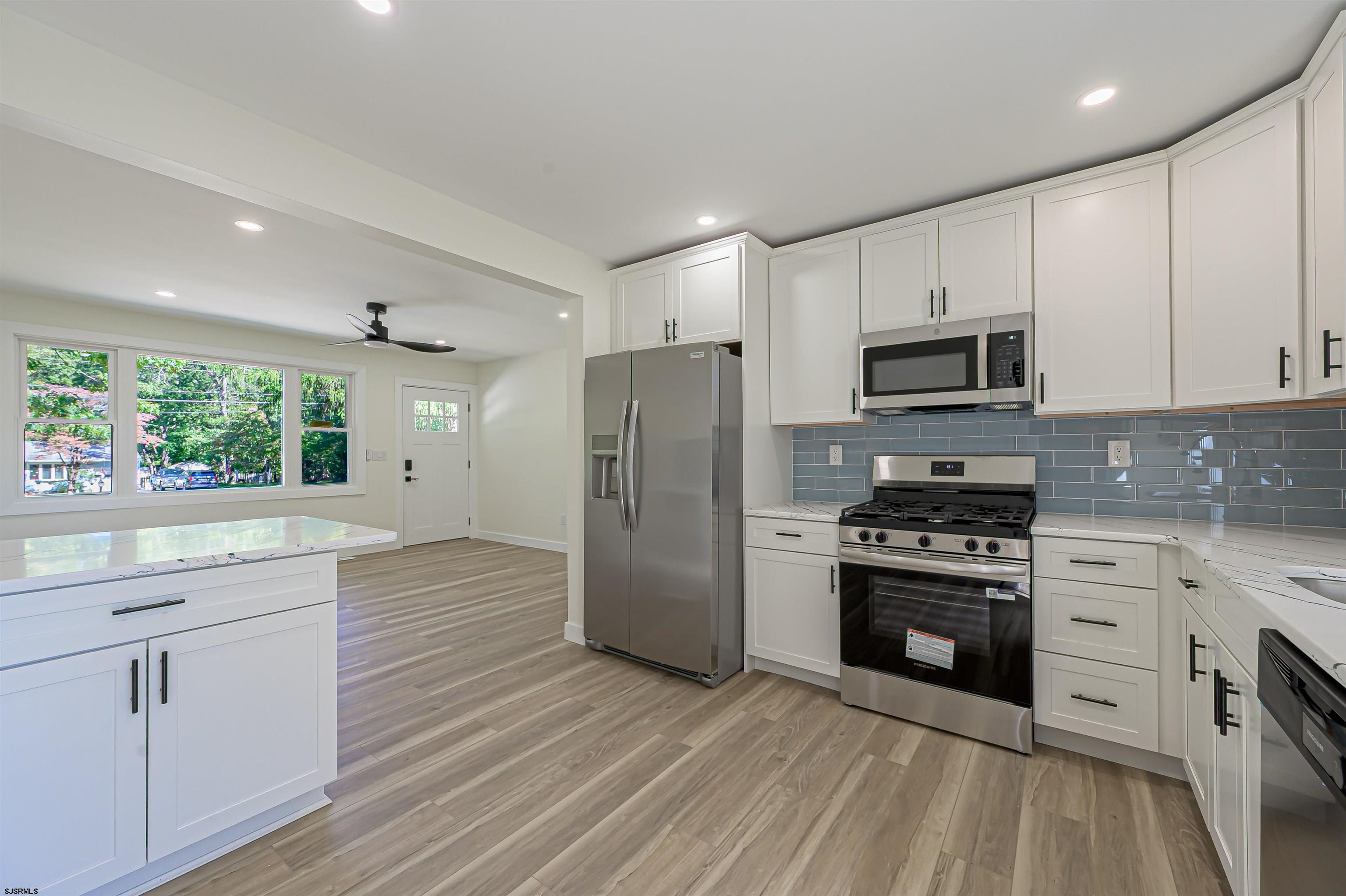310 Sandy Lane Galloway Township, NJ 08205 - Photo 23 of 48 a kitchen with stainless steel appliances a stove sink and refrigerator