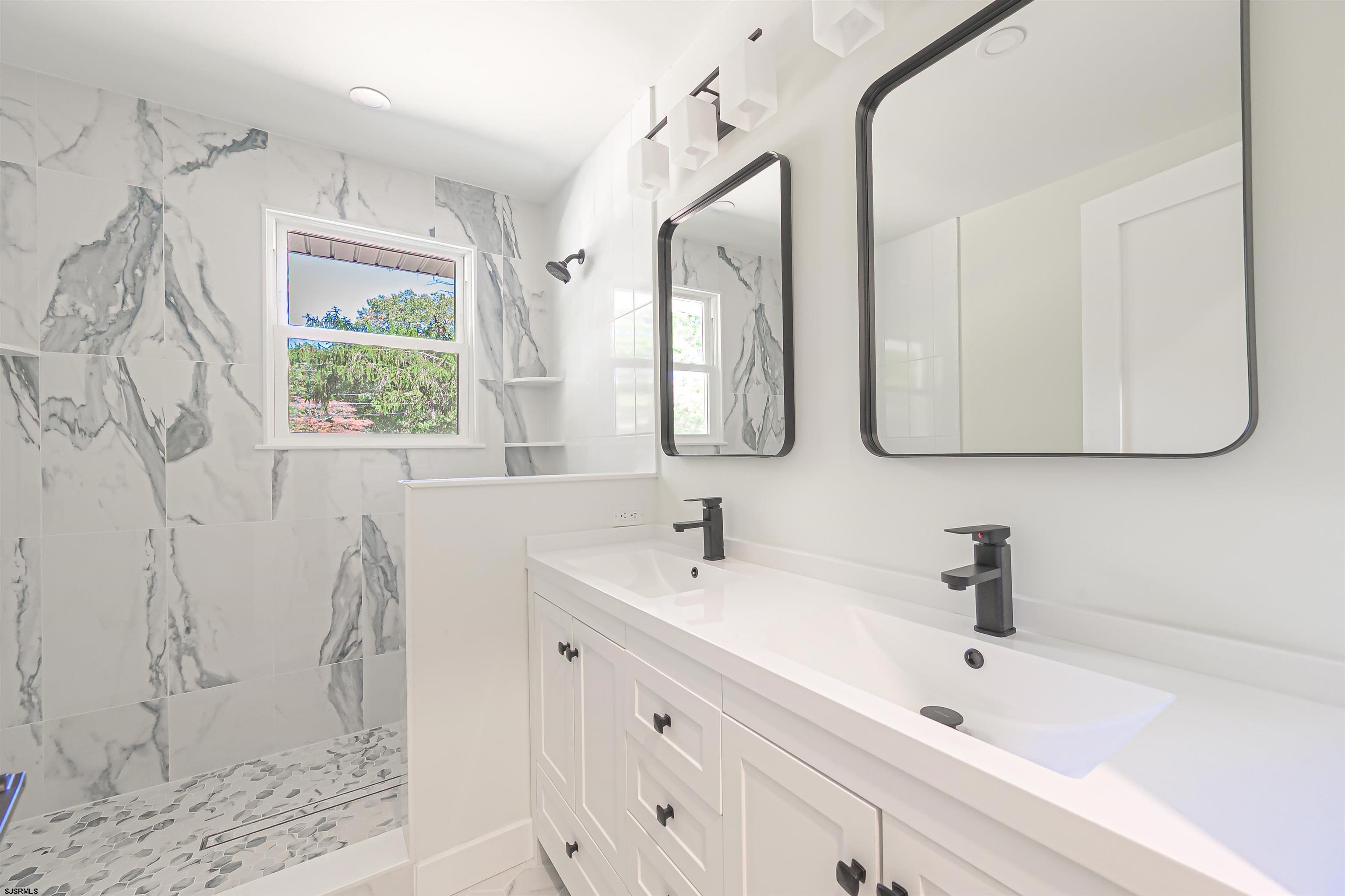 310 Sandy Lane Galloway Township, NJ 08205 - Photo 26 of 48 a bathroom with a double vanity sink mirror and
