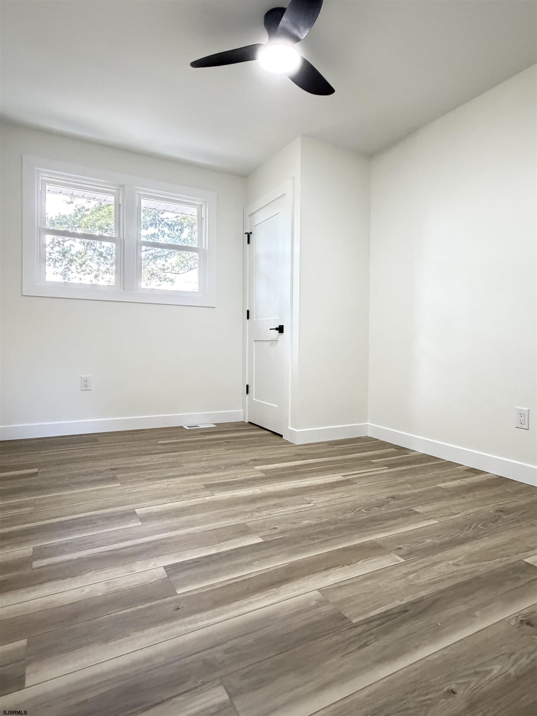 310 Sandy Lane Galloway Township, NJ 08205 - Photo 30 of 48 a view of empty room with wooden floor and fan
