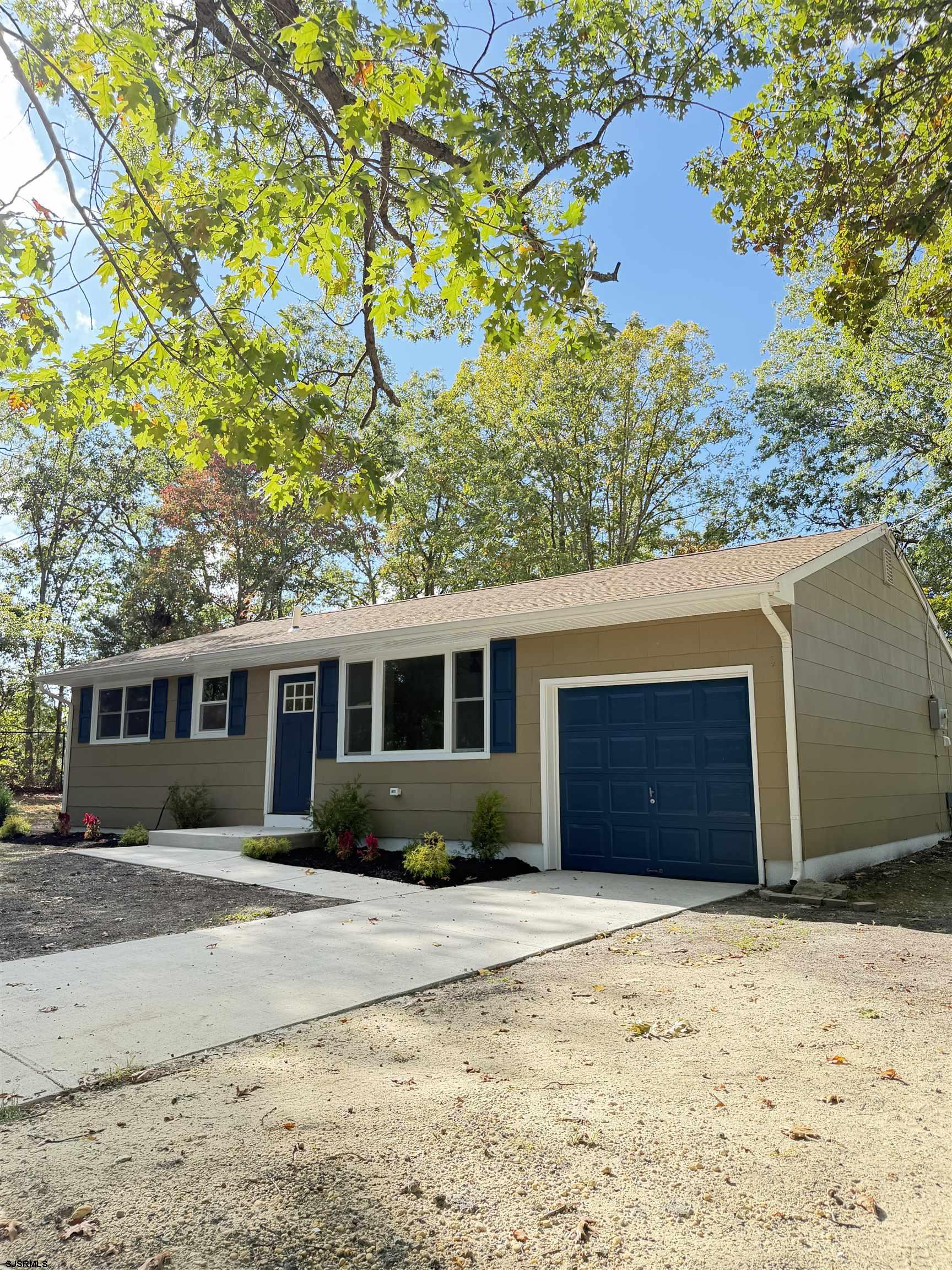 310 Sandy Lane Galloway Township, NJ 08205 - Photo 3 of 48 a front view of a house with a yard and garage