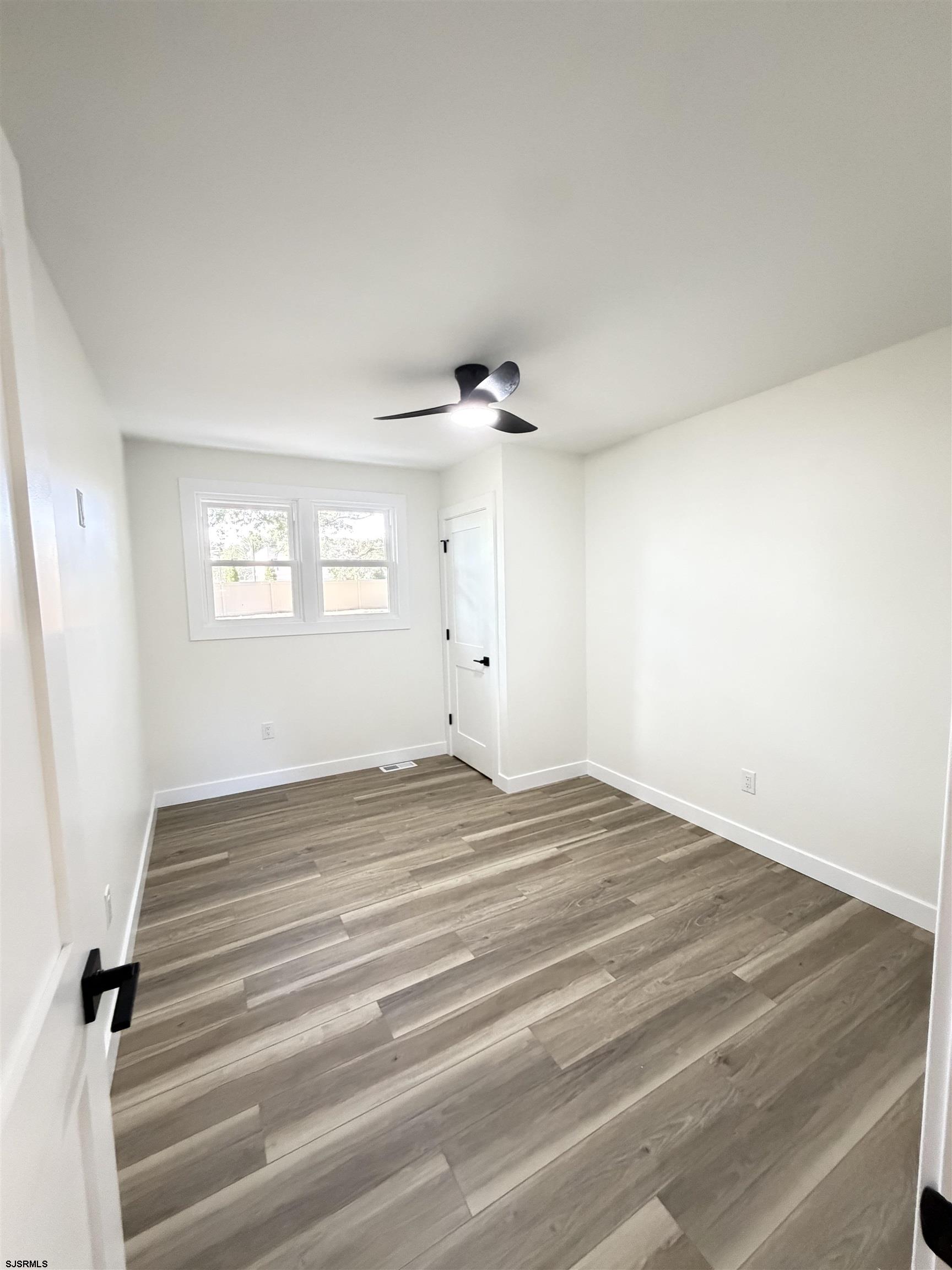 310 Sandy Lane Galloway Township, NJ 08205 - Photo 31 of 48 a view of empty room with wooden floor and fan