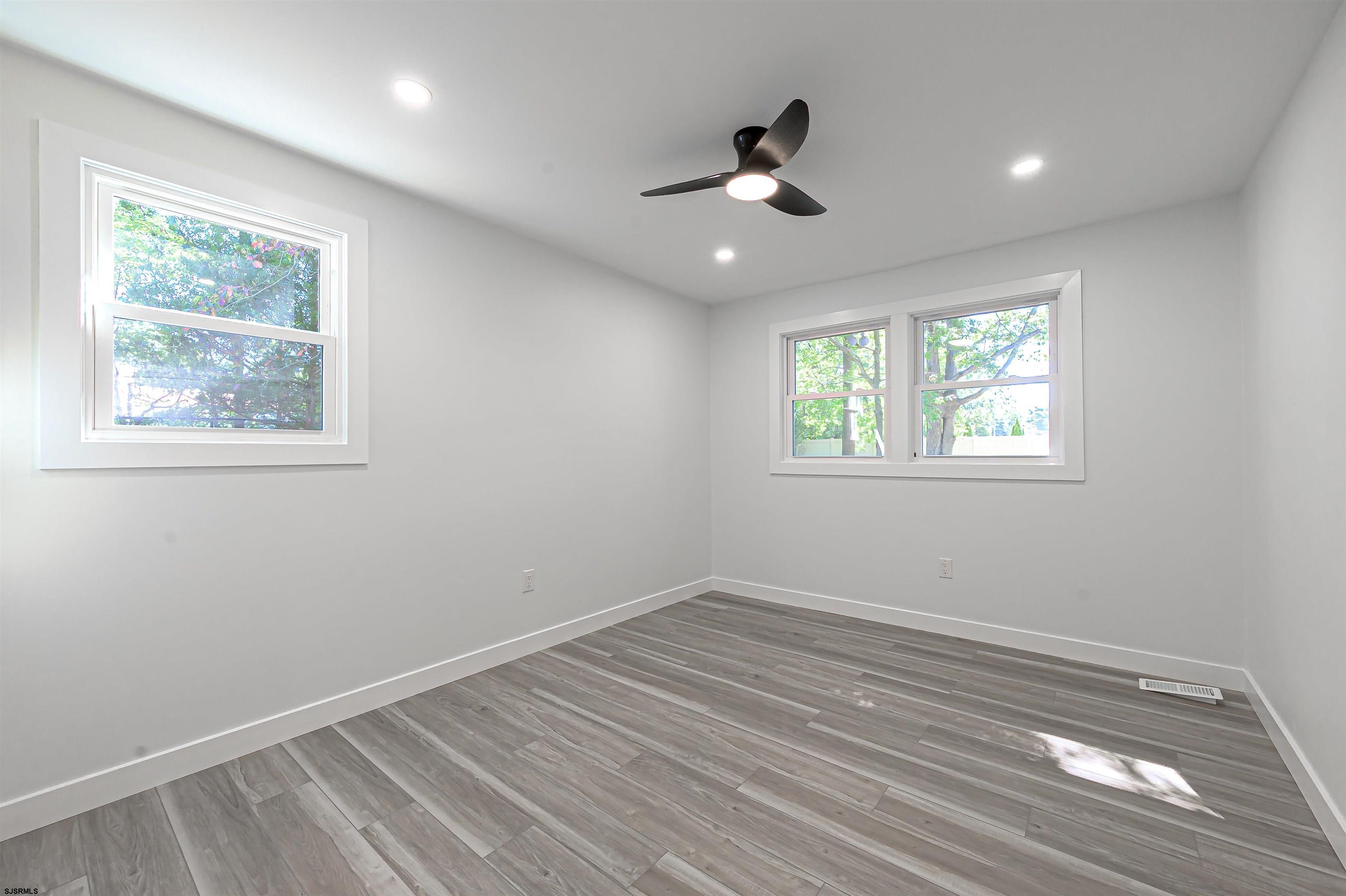 310 Sandy Lane Galloway Township, NJ 08205 - Photo 33 of 48 a view of empty room with wooden floor and fan