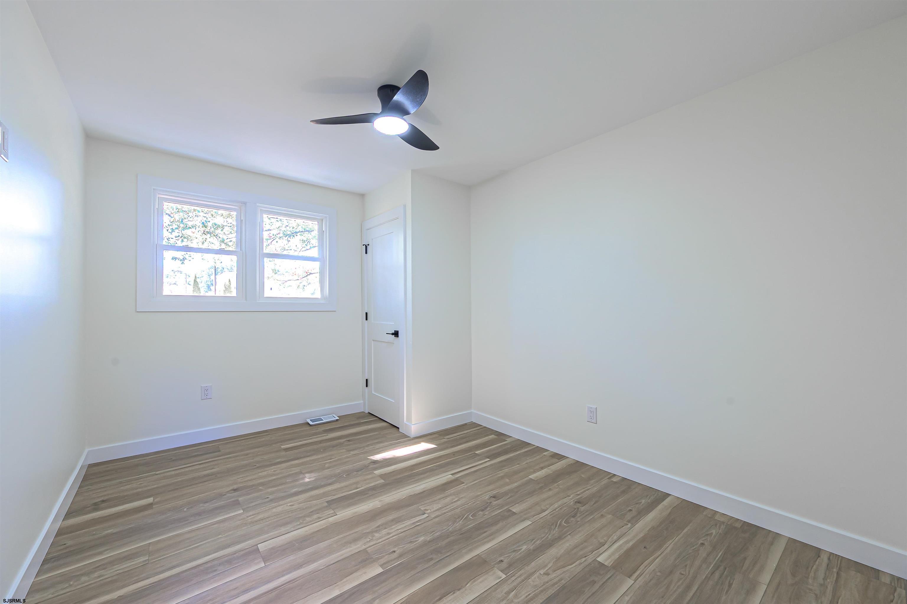 310 Sandy Lane Galloway Township, NJ 08205 - Photo 34 of 48 a view of empty room with wooden floor and fan