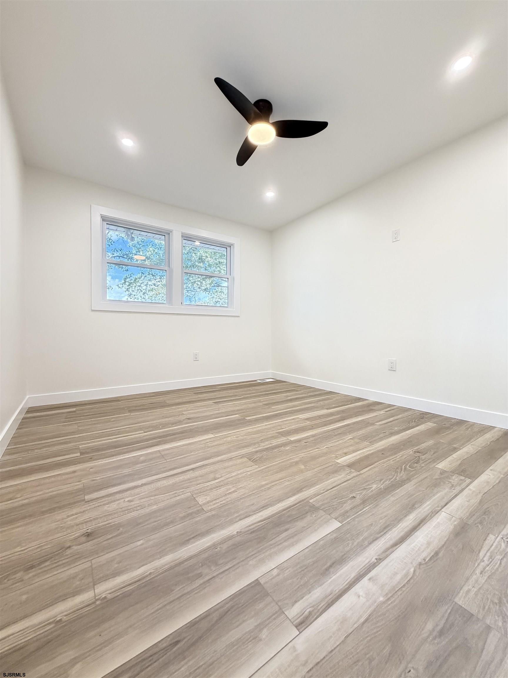 310 Sandy Lane Galloway Township, NJ 08205 - Photo 37 of 48 an empty room with wooden floor and windows