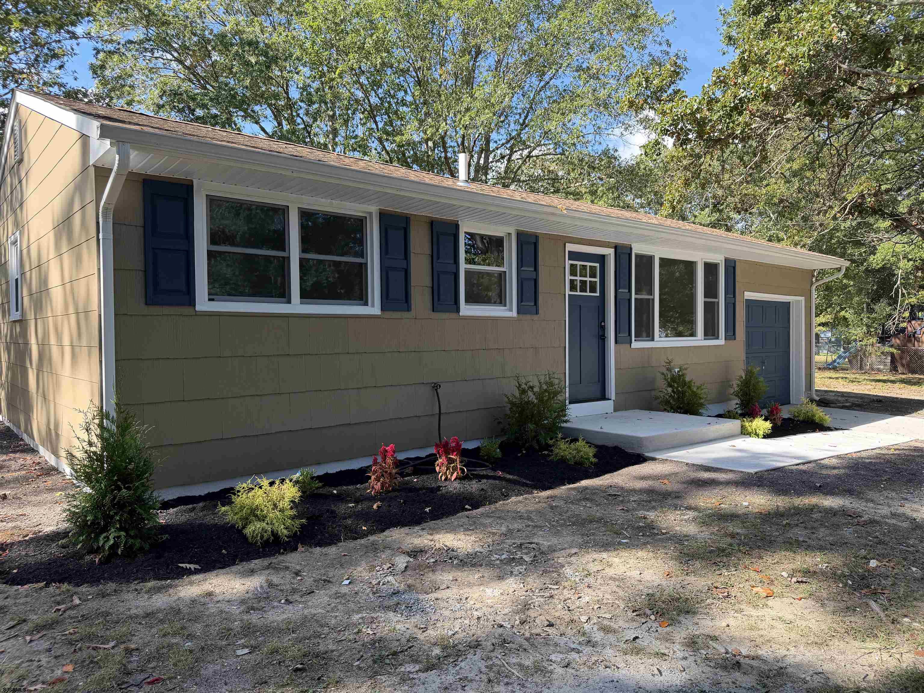 310 Sandy Lane Galloway Township, NJ 08205 - Photo 4 of 48 a front view of a house with a yard and potted plants