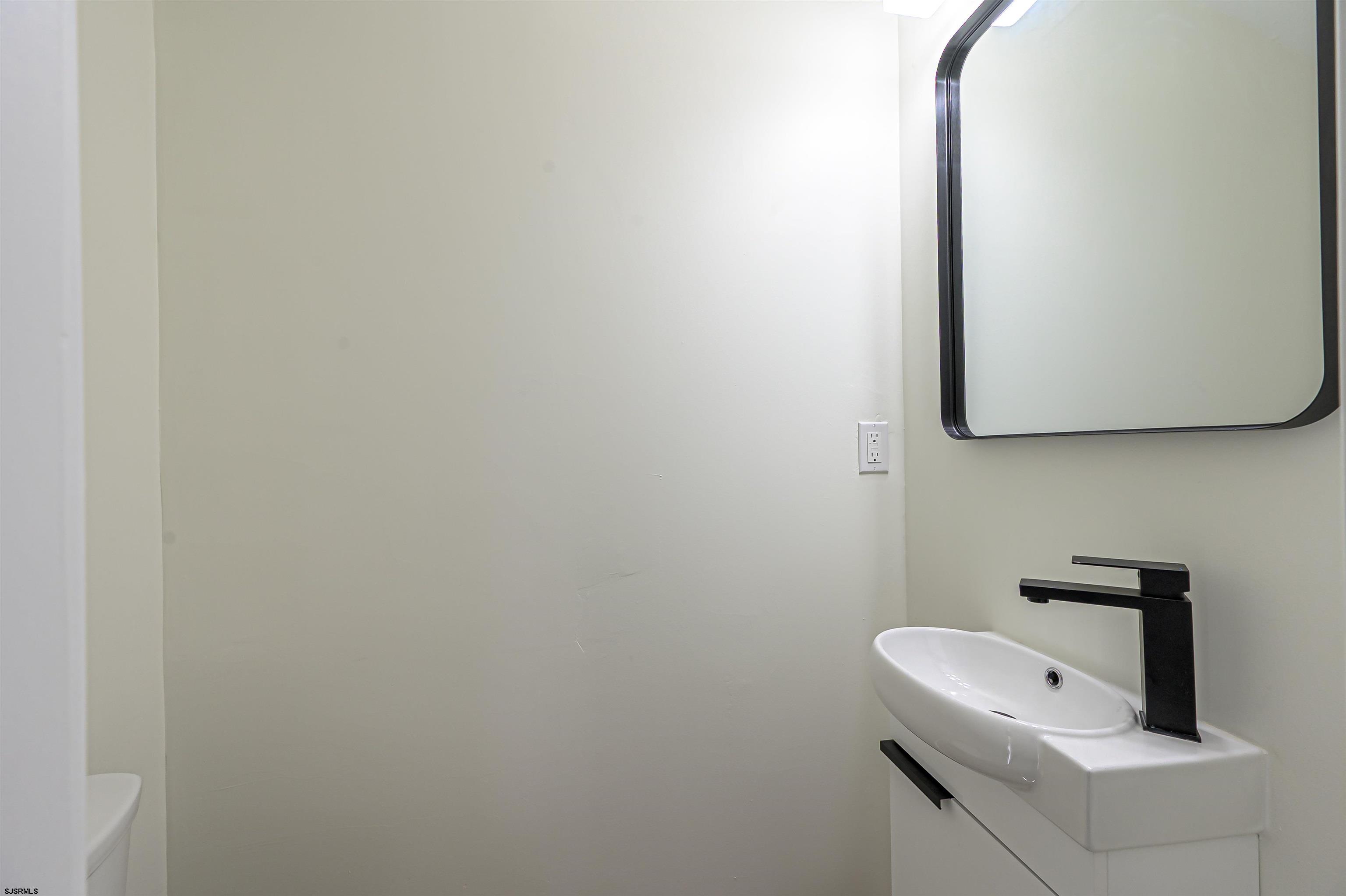 310 Sandy Lane Galloway Township, NJ 08205 - Photo 44 of 48 a bathroom with a sink and a mirror