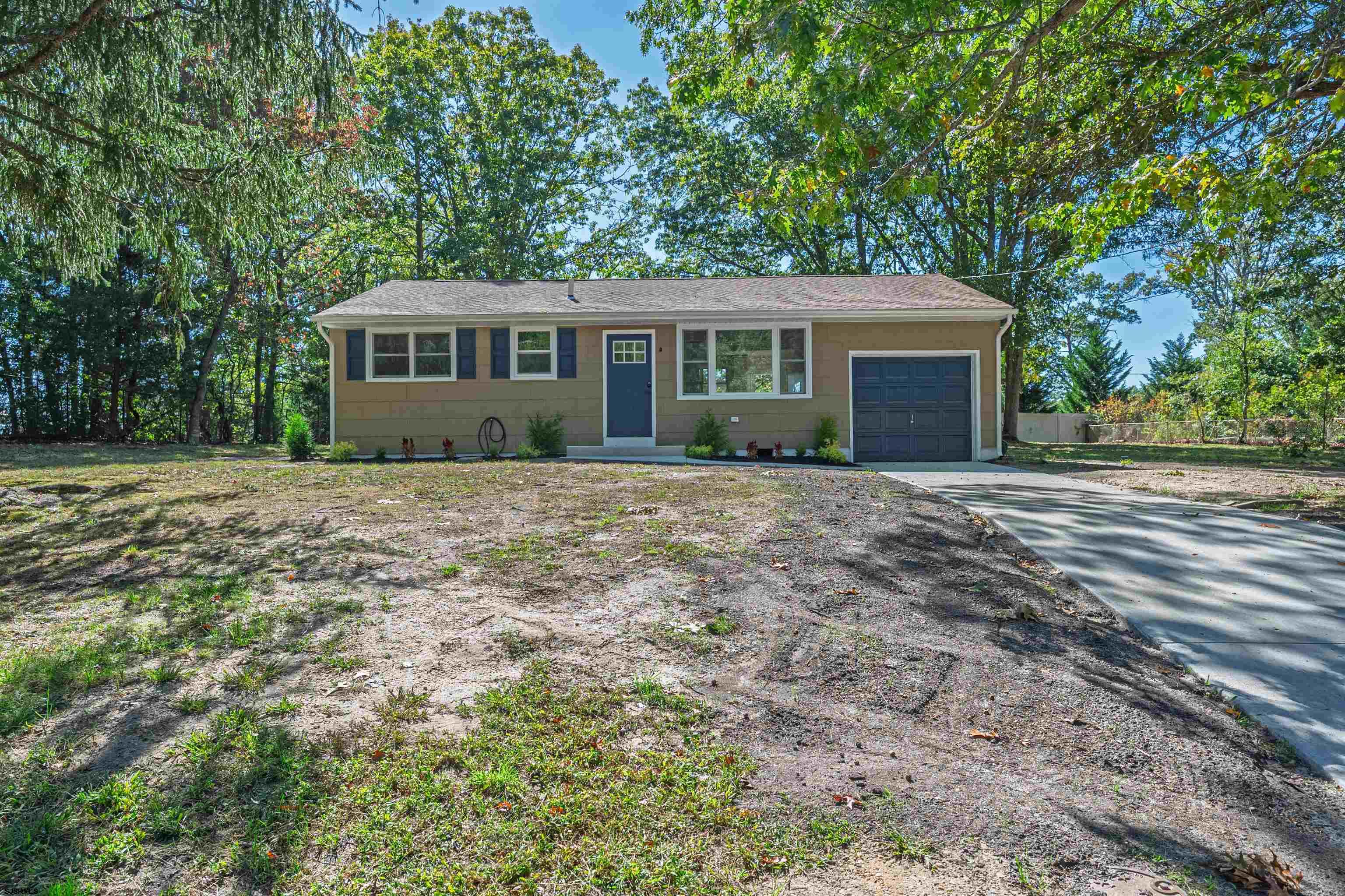 310 Sandy Lane Galloway Township, NJ 08205 - Photo 7 of 48 a front view of a house with a garden