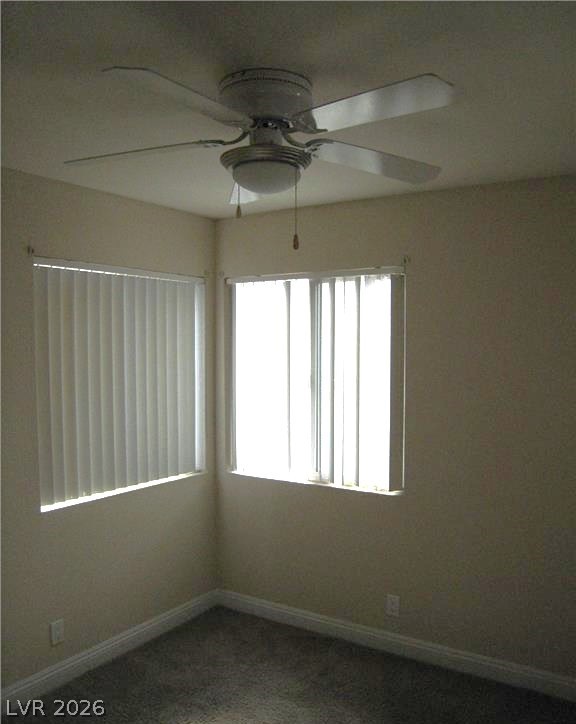 1844 North Decatur Boulevard, Unit 204 Las Vegas, NV 89108 - Photo 5 of 8 Well-lit room with corner windows and a convenient ceiling fan for comfort.