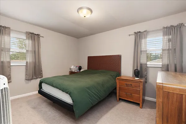 a bedroom with a bed and window