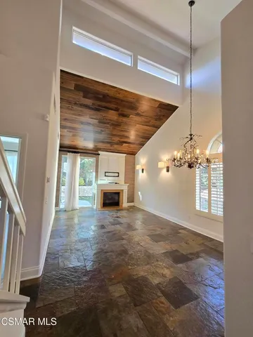 a view of a livingroom with a ceiling fan and window