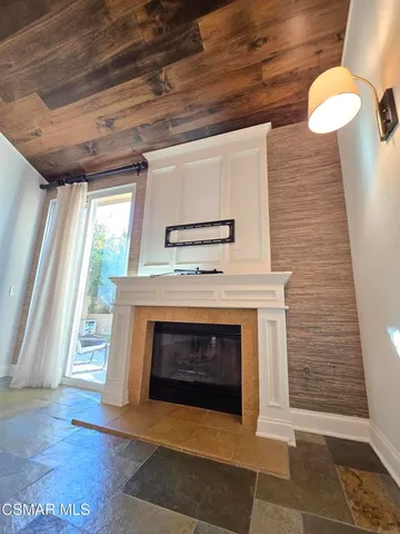 a living room with a fireplace and a wooden floor