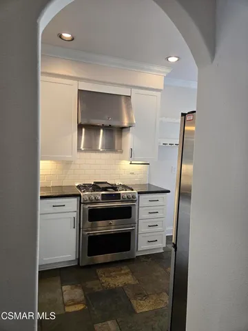a kitchen with stainless steel appliances a stove and a refrigerator