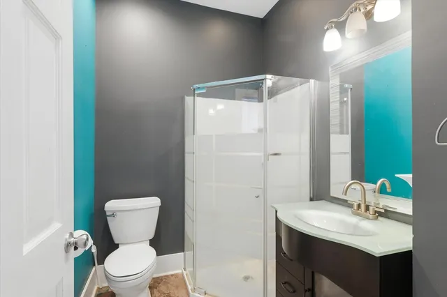 a bathroom with a sink toilet and shower