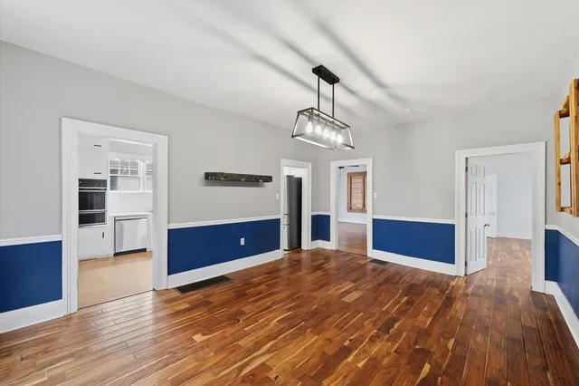 a view of a room with wooden floor and staircase