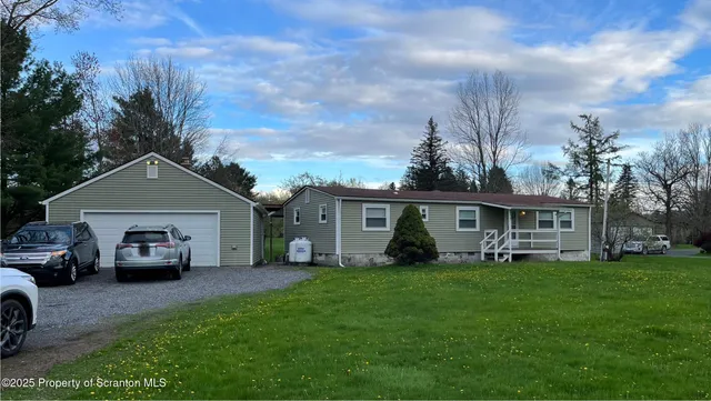 a front view of house with yard and green space
