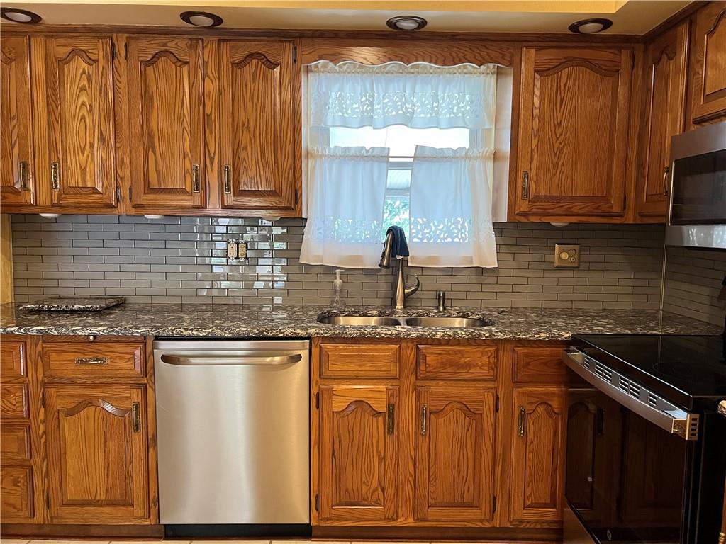 Well equipped kitchen with all stainless steel appliances. View to back yard.