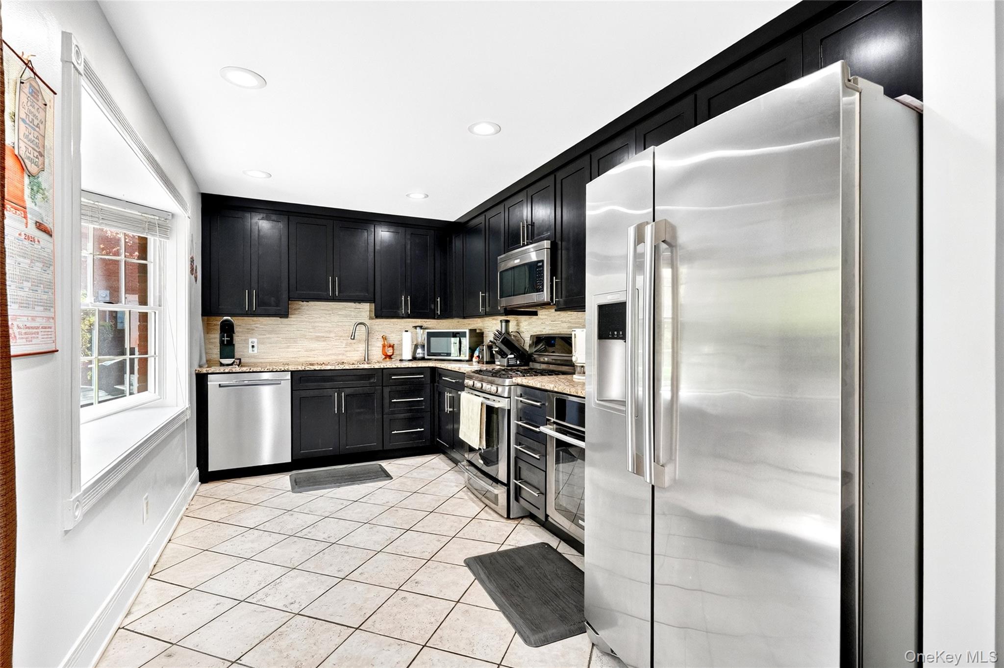 47 Westbrook Road, Unit 47 Newburgh, NY 12550 - Photo 13 of 43 a kitchen with stainless steel appliances kitchen island granite countertop a refrigerator and a stove top oven